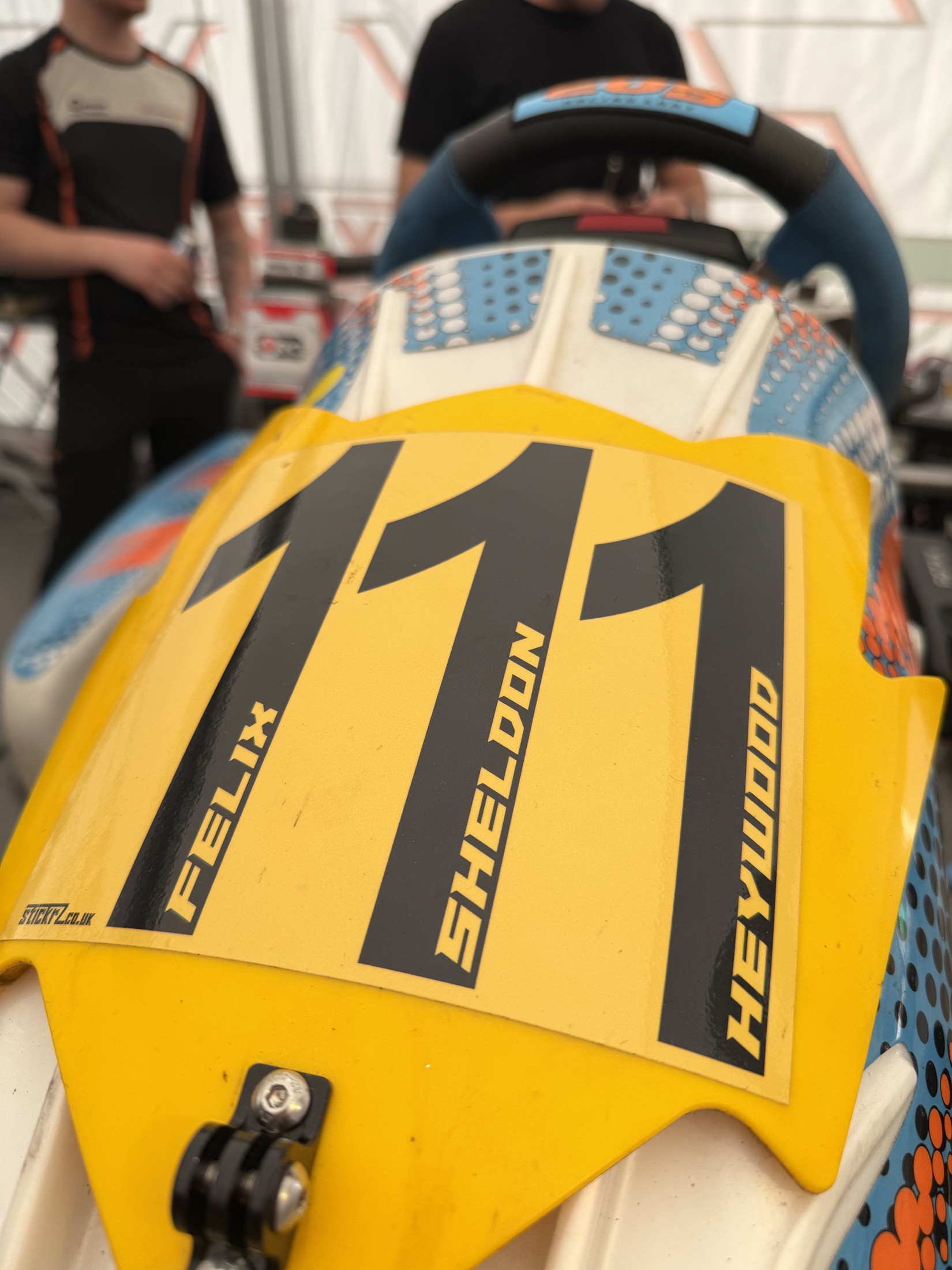 Close-up of Felix's yellow number 111 kart panel